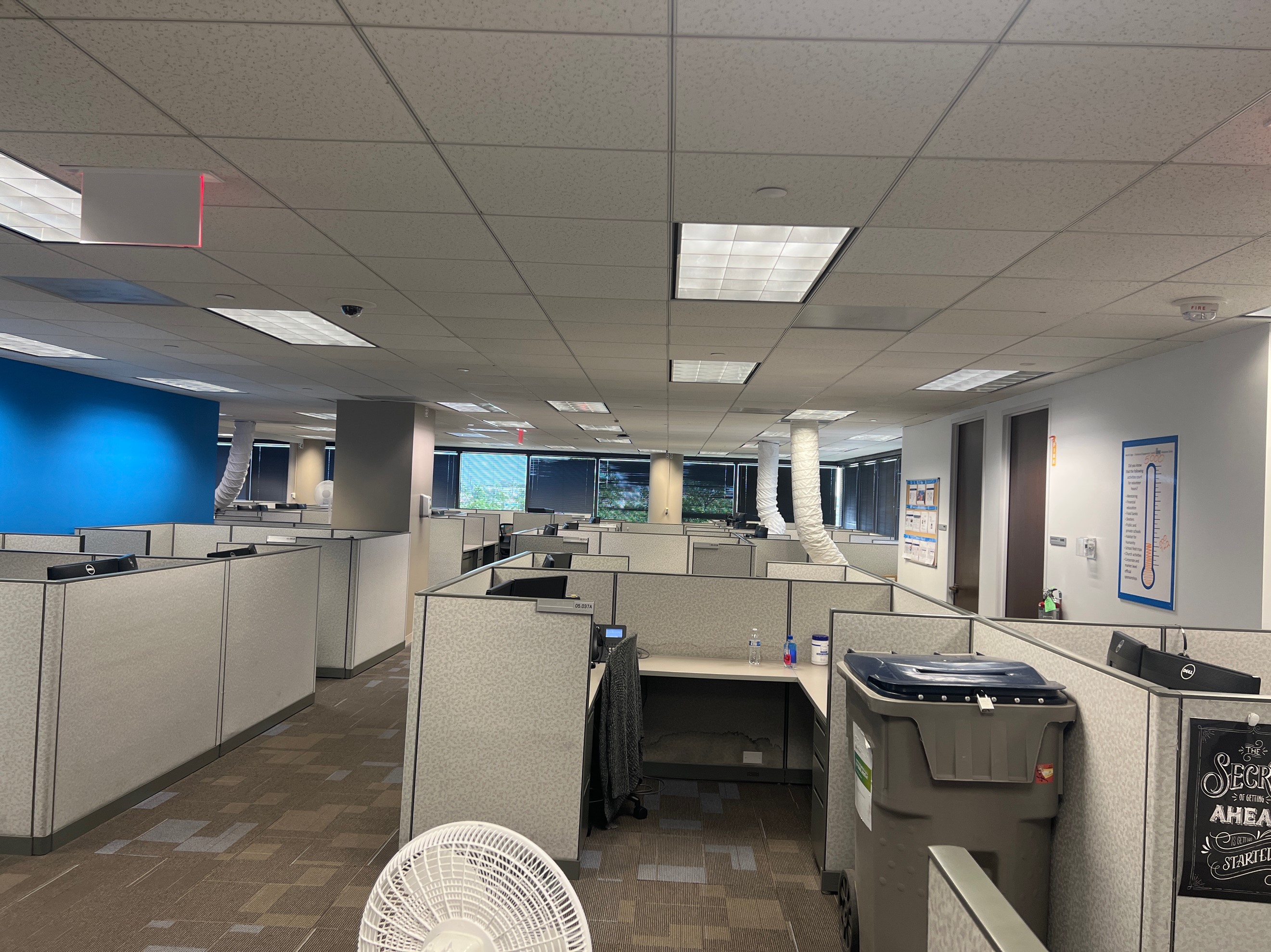 A high rise building floor with several office cubicles being cooled by temporary AC coolers.